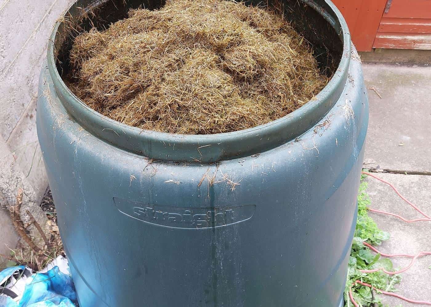 A garden compost bin full of decomposing plant material